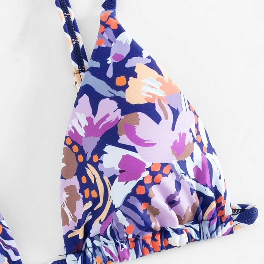 Women's floral print triangle swimsuit with briefs bottom and integrated bag.