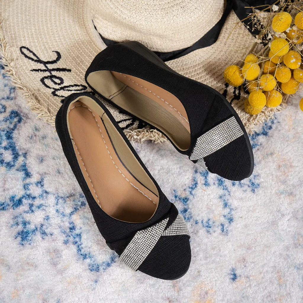 Black women's slip-on casual shoes with rhinestones on the fabric upper and a chunky heel.