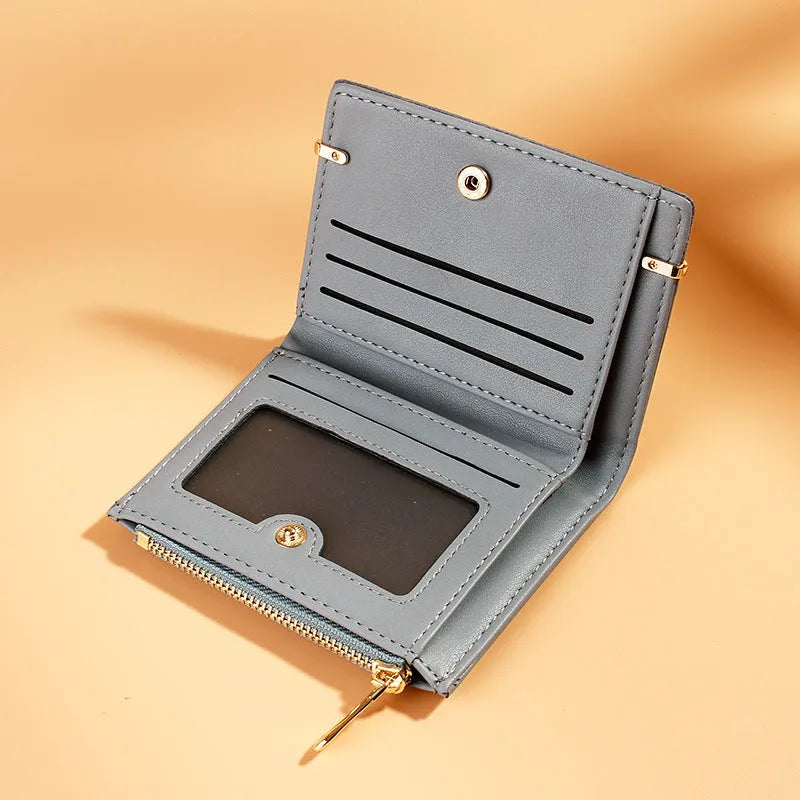 A ladies foldover wallet with a zipper, made from PU leather, shown open to reveal multiple card slots, a bill compartment, and a coin pocket.