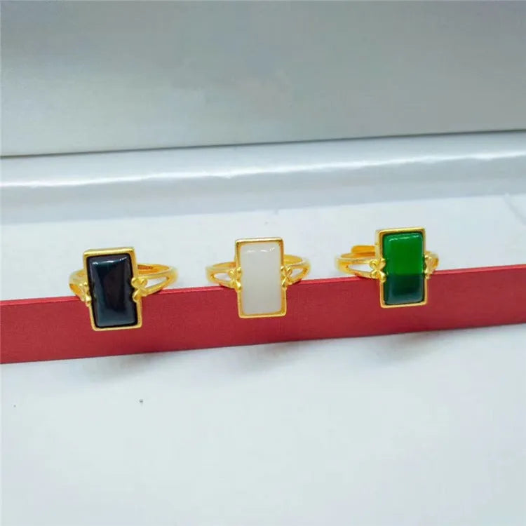 Adjustable brass electroplated ring with gold plating and embedded gemstones in black, green or white options