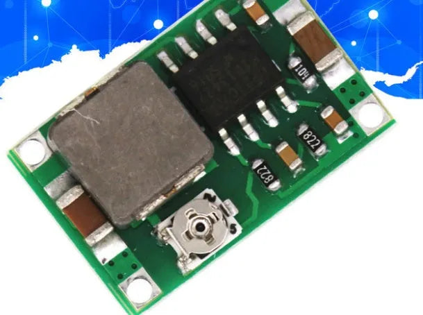 Mini 360 green DC-DC buck converter step down power supply module on white background
