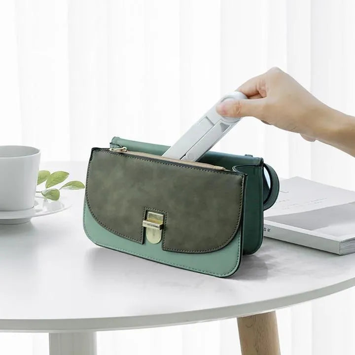 Black foldable aluminium tablet holder showing adjustable angles and flat-folded profile