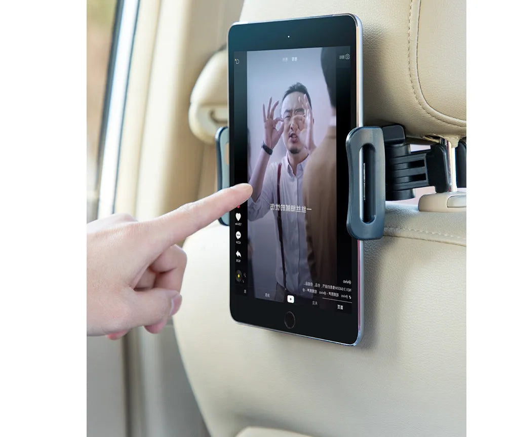Black car phone holder attached to vehicle rear seat base with universal bracket holding tablet