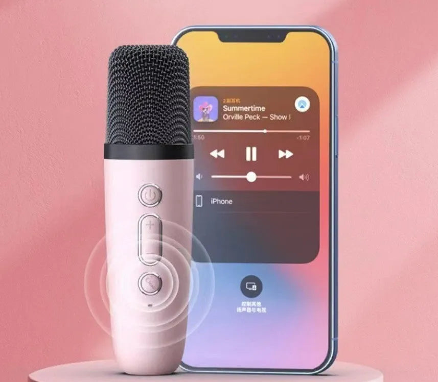 Pink portable Bluetooth karaoke speaker with coloured lights and built-in microphone on a white background.