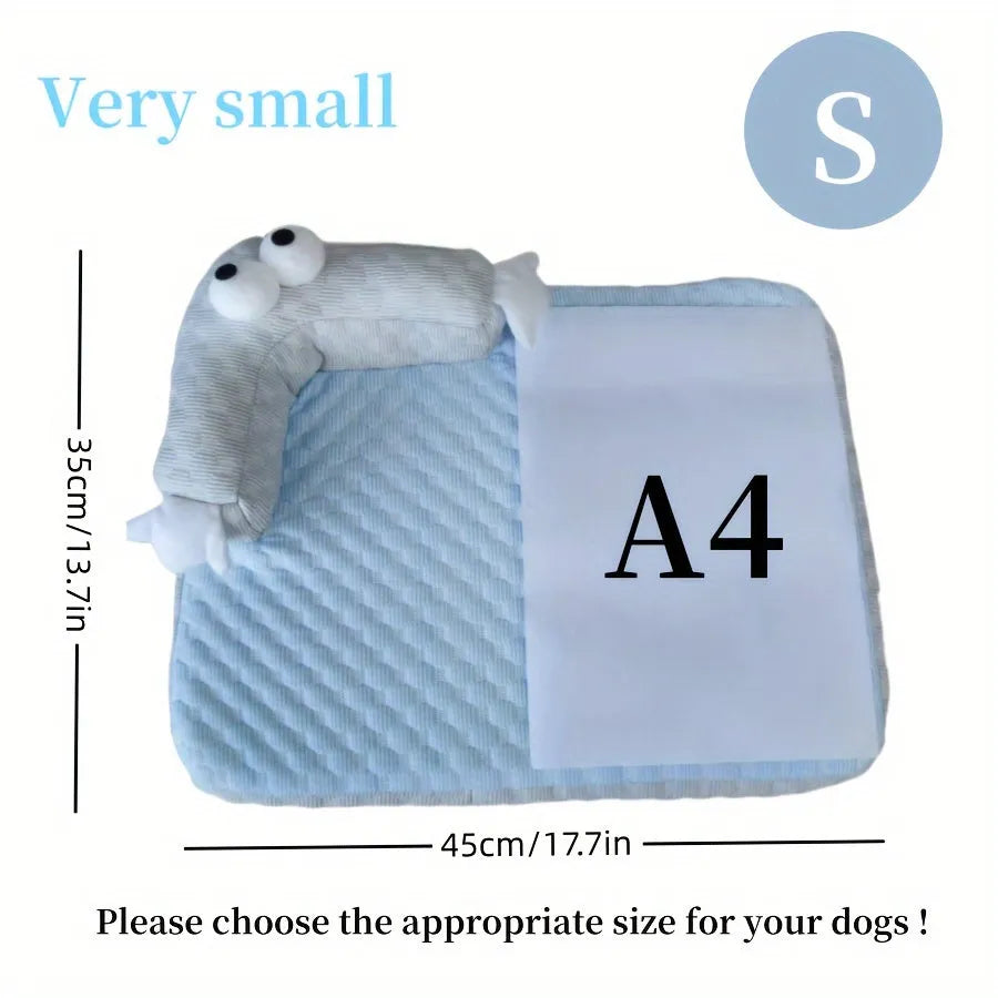 Blue pet bed cushion with big-eyed monster design for dogs and cats on a wooden floor.