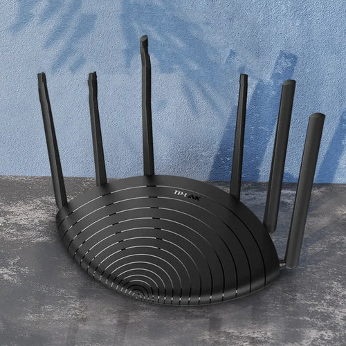 TL-WDR7661 AC1900 Gigabit wireless router shown in a home setting with network cable.