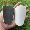 Extra small mini football shin guards in black and white colours showing 8x5cm plastic construction