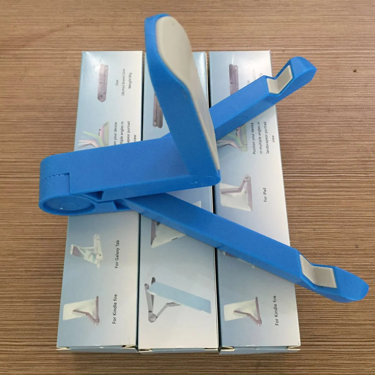 Black foldable aluminium tablet holder showing adjustable angles and flat-folded profile