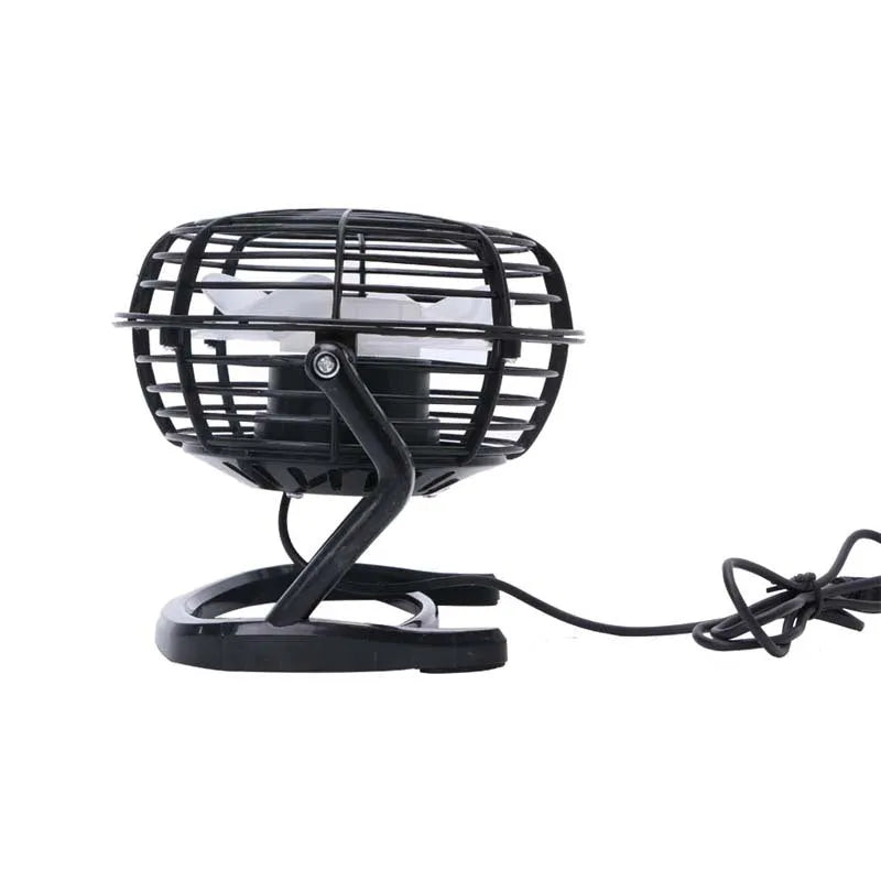 Mini black USB desk fan with adjustable angle on wooden desk next to laptop