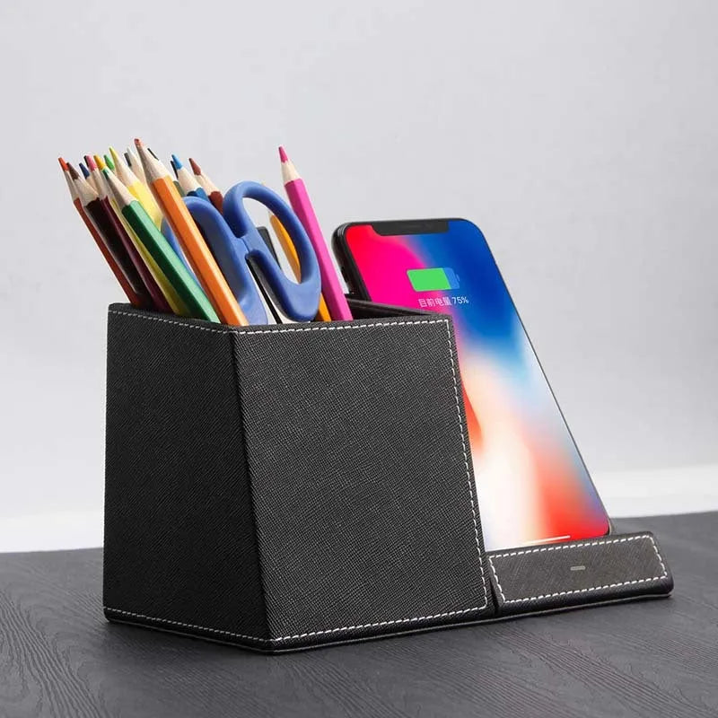 Black leather desk organiser with wireless phone charging pad and pen holder slots.