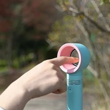 Compact portable bladeless fan on its base, shown in blue, with a USB cable for charging.