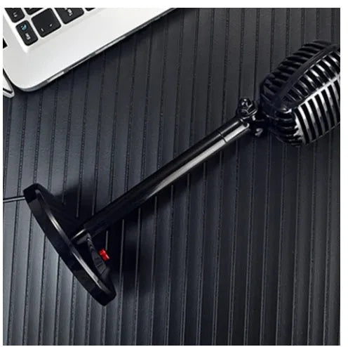 Black USB computer microphone with adjustable stand on desktop
