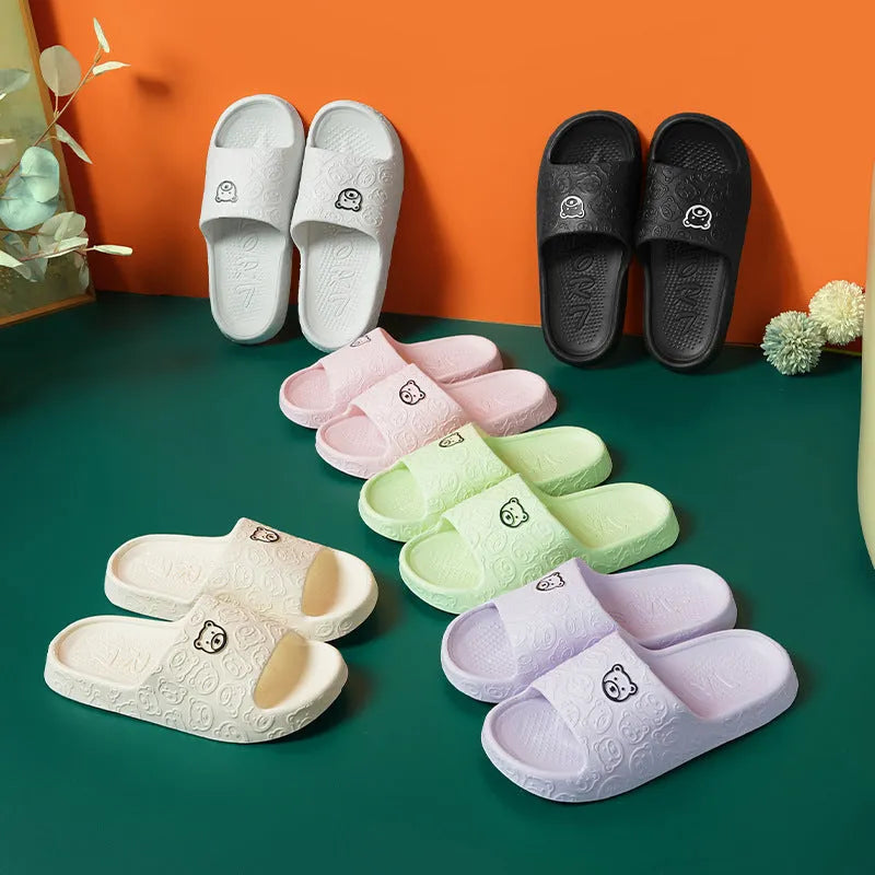 Pair of cute bear EVA indoor slippers in pink with thick non-slip soles.