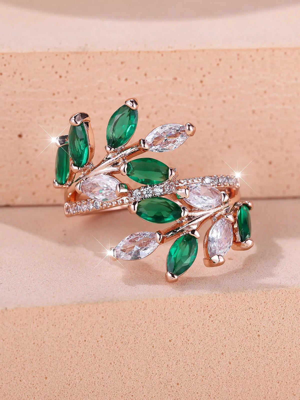 Adjustable horse eye zircon leaf ring in rose gold or platinum plating on a model's hand.