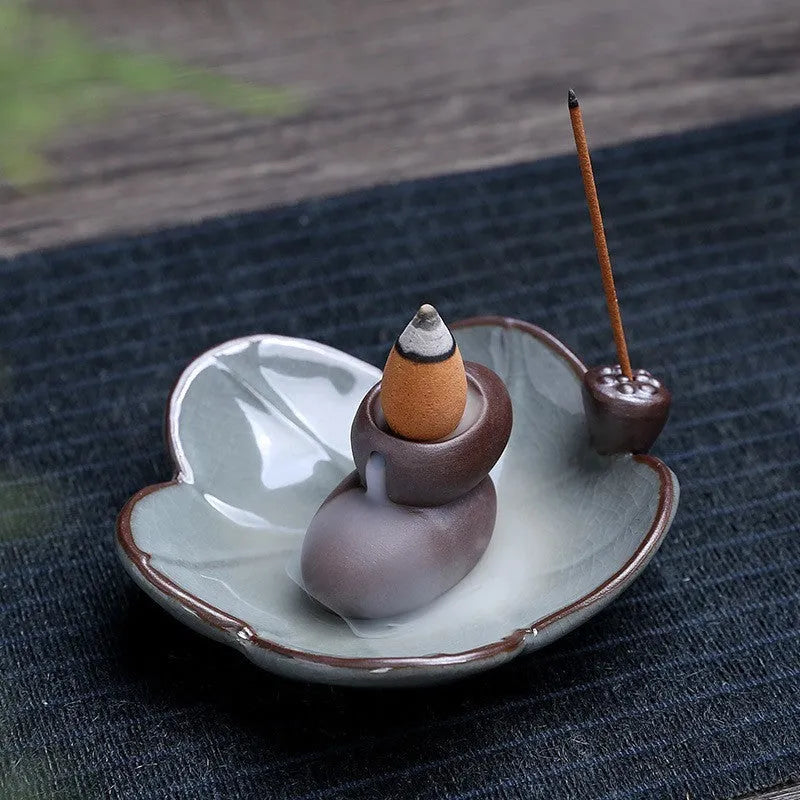 Ceramic reverse flow incense burner with purple clay construction and traditional good luck decorative motifs