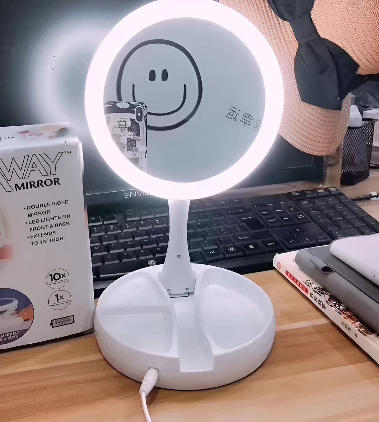 White acrylic foldable LED vanity mirror with USB charging port and double-sided design on a table