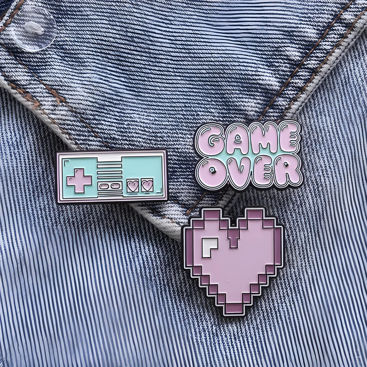 Stereo game console design metal badge with pin back, shown in one of three alloy colour options.