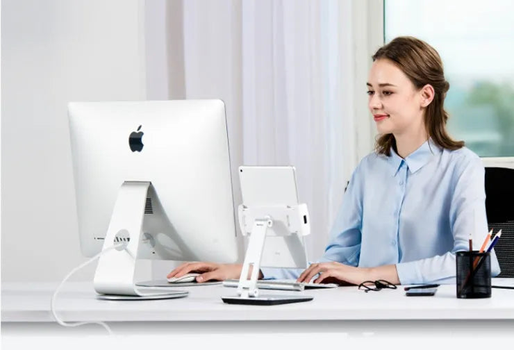 Silver foldable aluminium tablet phone holder showing 360-degree rotation mechanism and silicone anti-slip pads