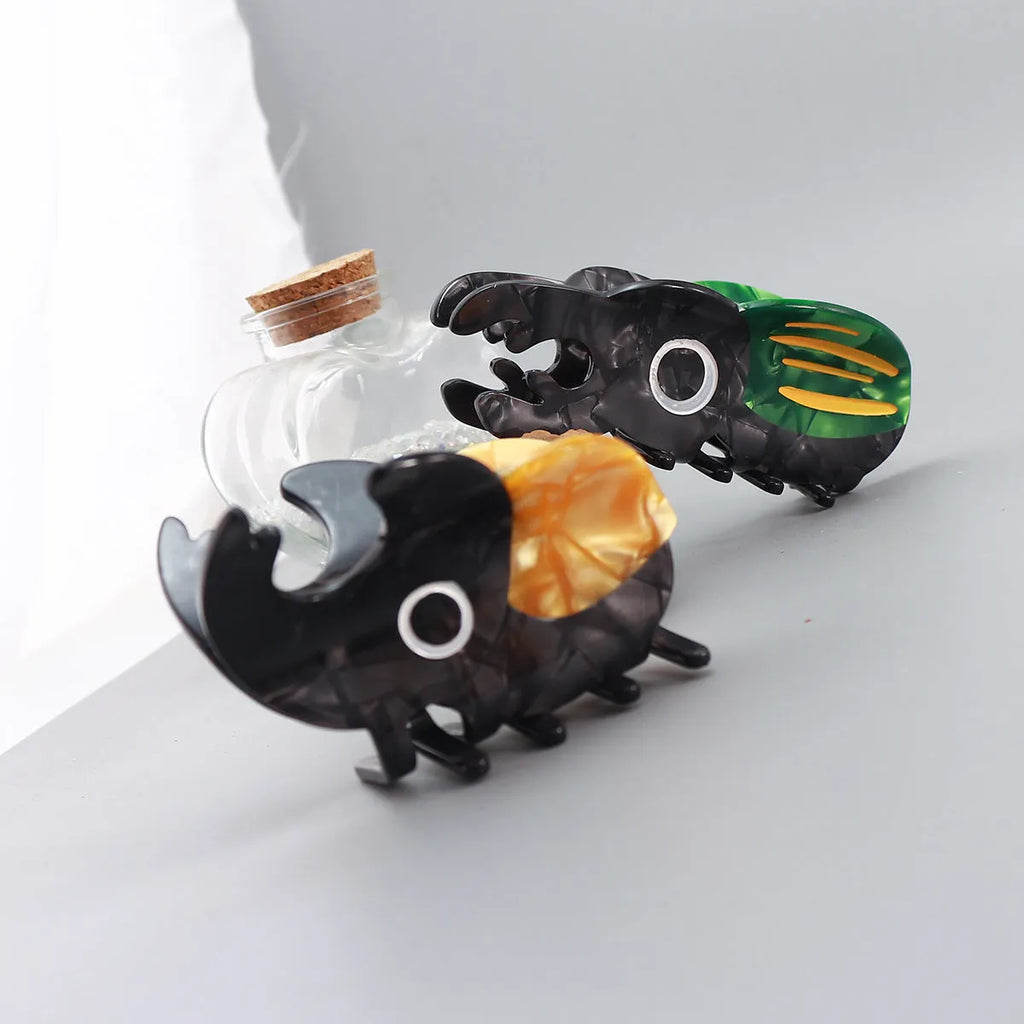 Handmade cellulose acetate beetle grip accessory in green, orange or white insect biology colours