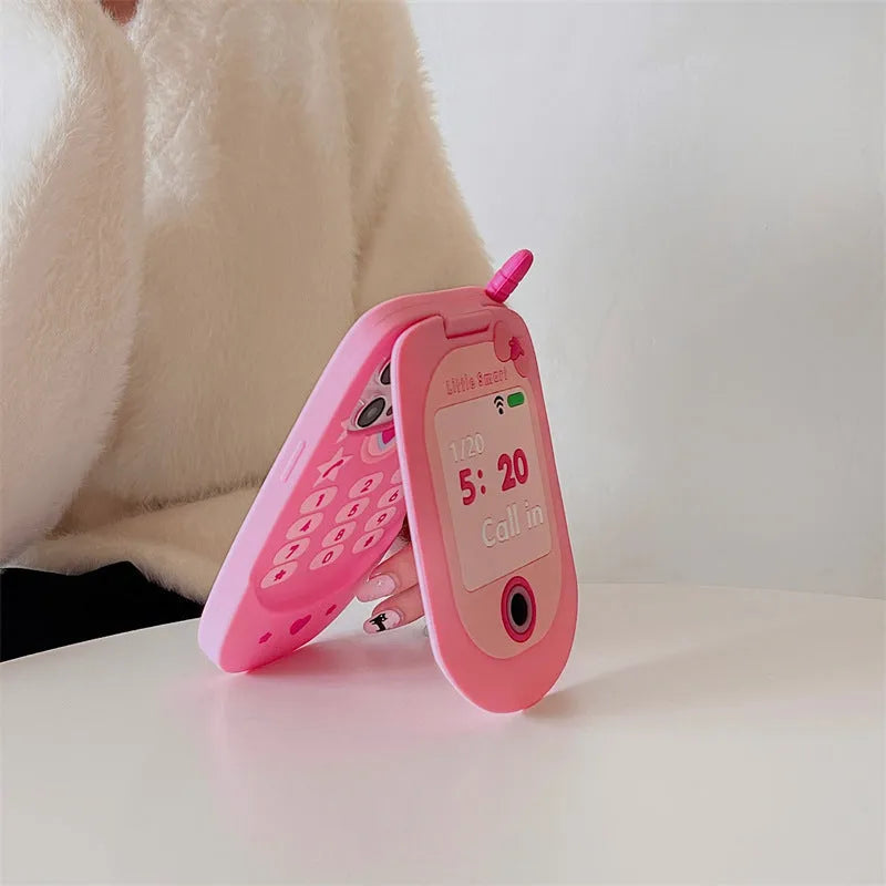 Light pink silicone flip phone case with built-in mirror for iPhone, showing cute cartoon design.