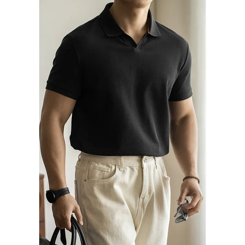 Man wearing a classic blue short-sleeved cotton blend polo shirt, showing regular fit and button placket.