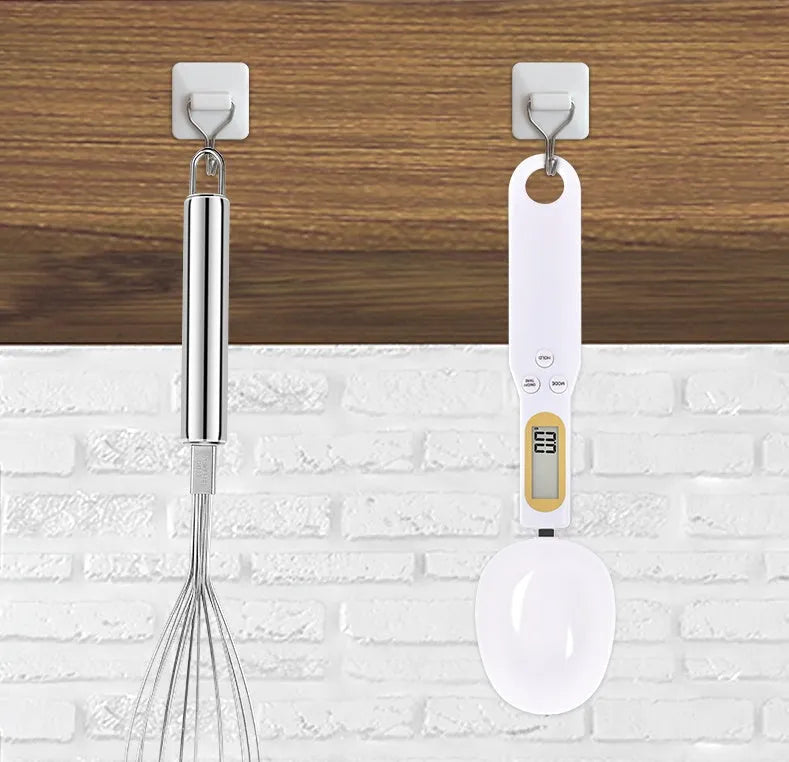 Black electronic measuring spoon scale showing digital display and integrated spoon design for kitchen weighing