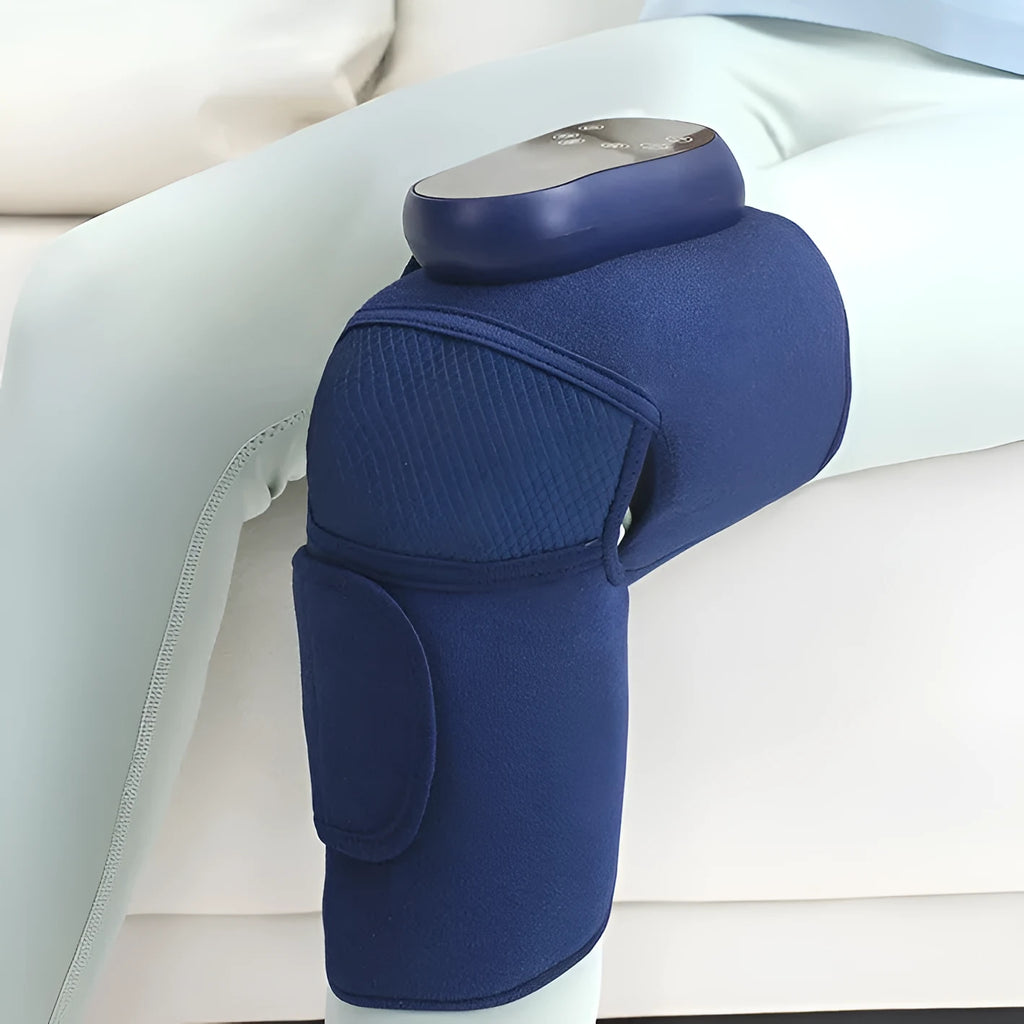 Blue self-heating knee massager wrap with adjustable straps, showing control panel.
