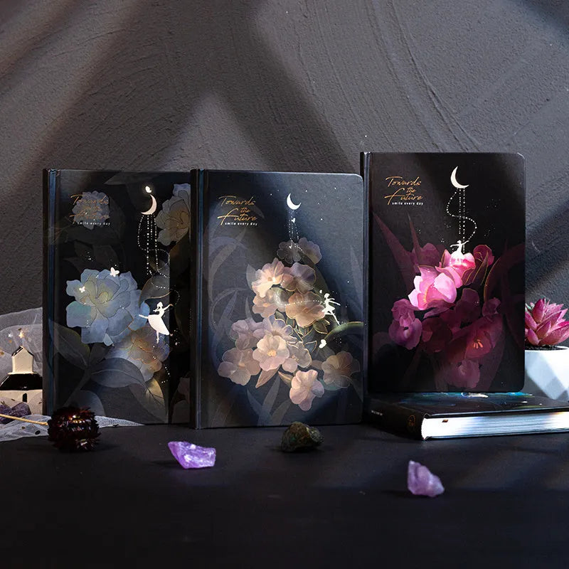 A5 notebook with luminous holographic cover lying flat, showing colourful illustrated interior pages.