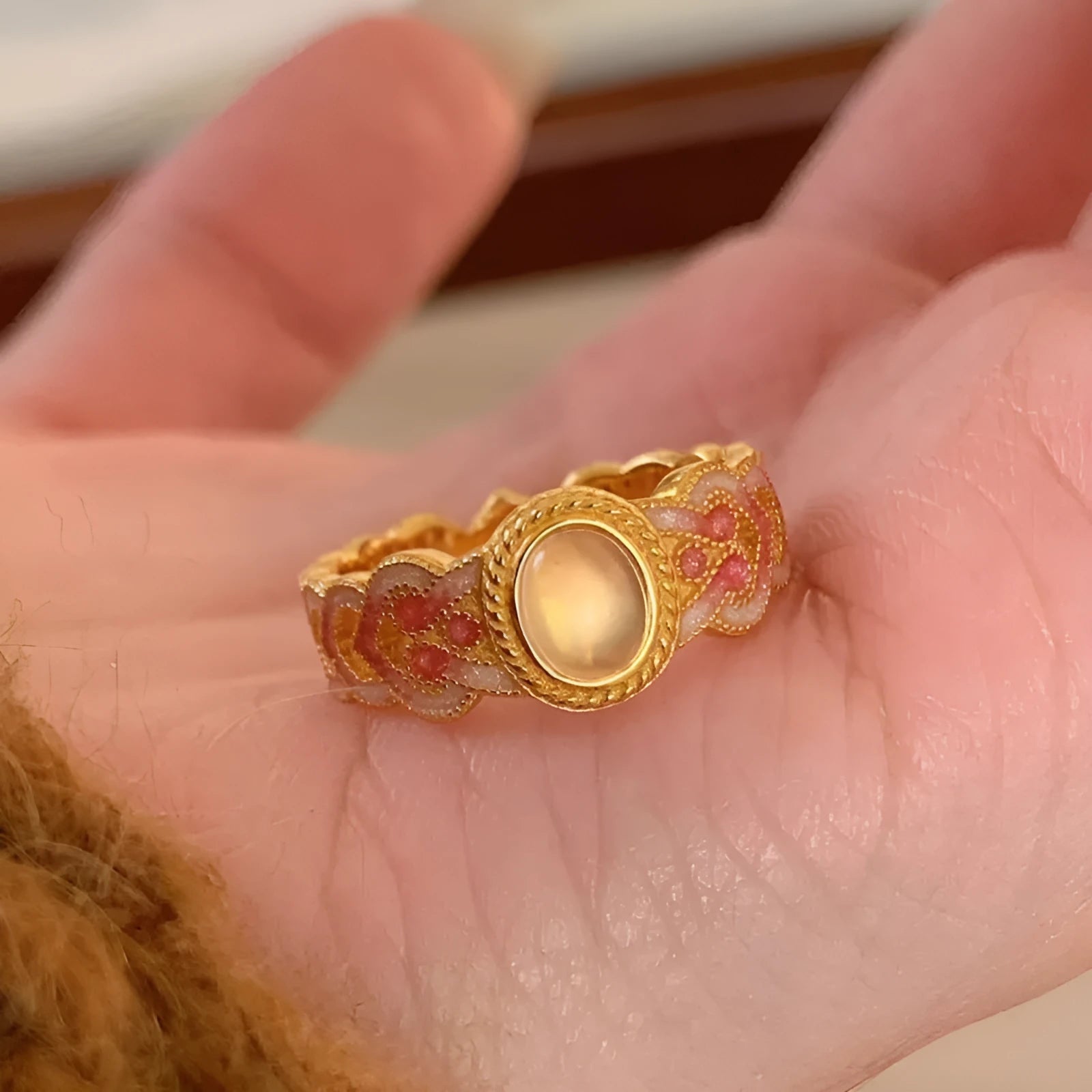 Pink crystal enamel geometric open ring on a gold plated copper band for women.