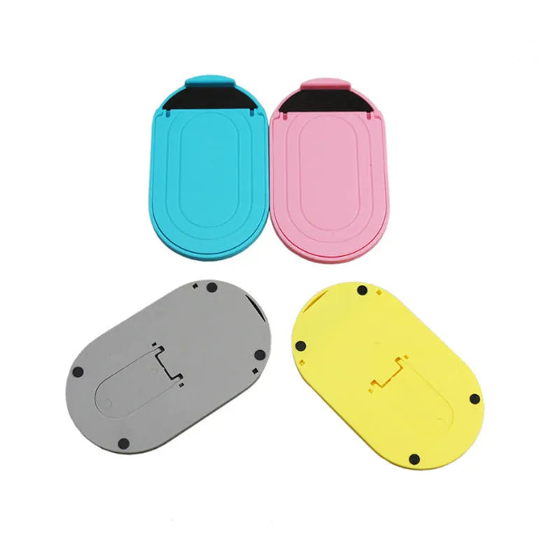 Plastic lazy bracket mobile phone stand in six colour options: black, blue, grey, pink, white, and yellow.