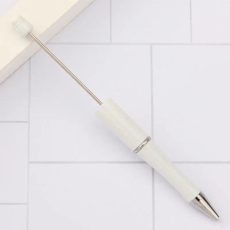 Ballpoint pen with colourful spinning plastic beads on barrel, shown in a gradient purple finish.