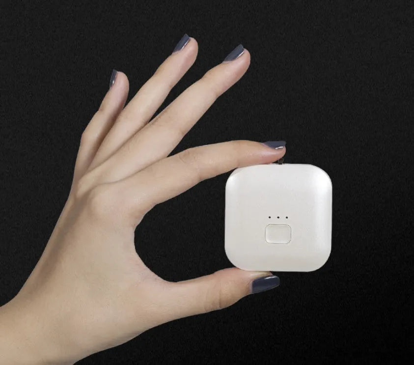 Mini USB air purifier necklace in pink, showing compact dimensions and wearable design.