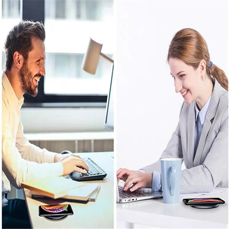 Black Qi fast wireless charging pad on a desk next to a smartphone, showing a blue LED charging indicator light.