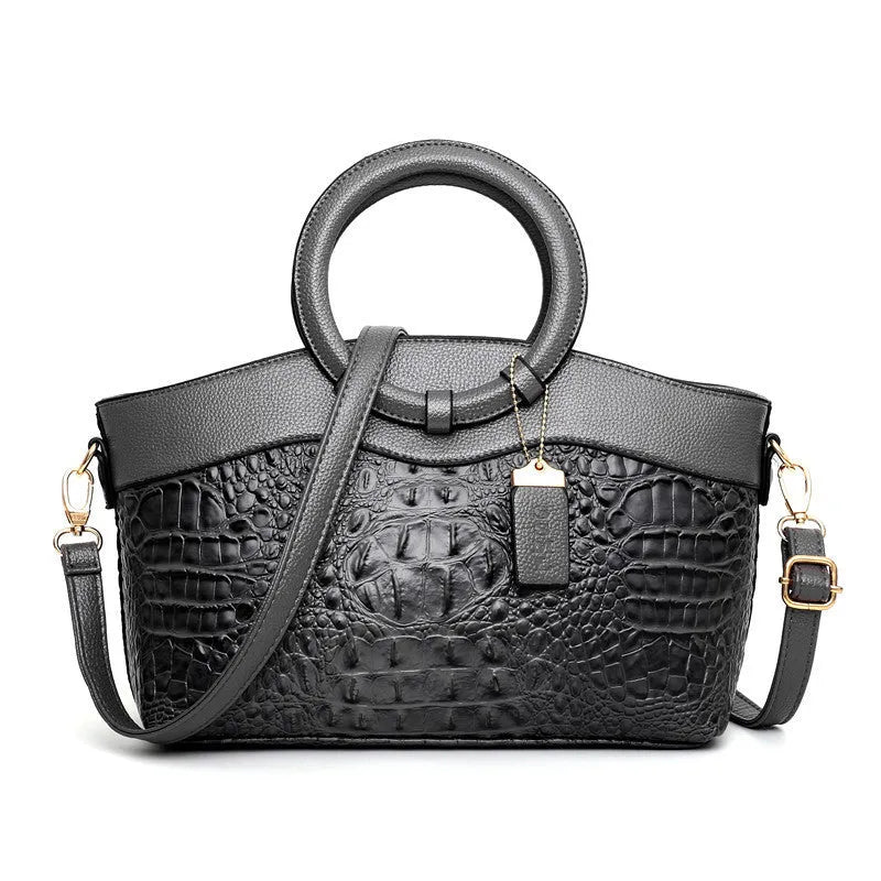 Fabric women's shoulder handbag in multiple colours showing zipper pockets and organisational compartments.