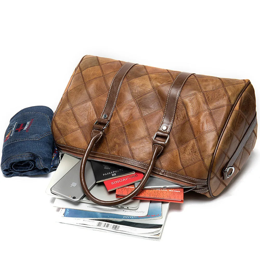 Vintage brown cowhide leather men's duffel bag with a single shoulder strap.