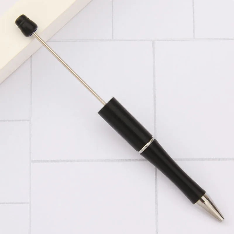 Ballpoint pen with colourful spinning plastic beads on barrel, shown in a gradient purple finish.