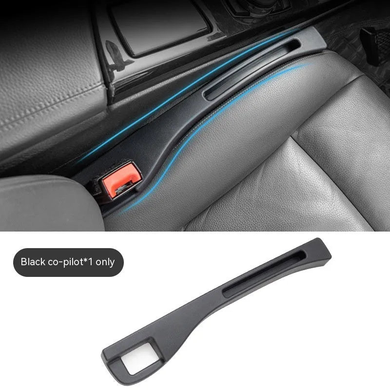Black plastic car seat gap storage pocket with handle placed between vehicle seats.