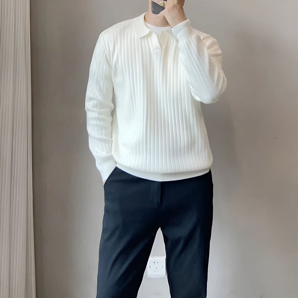 Man wearing a black and white striped knitted jumper with a lapel collar.