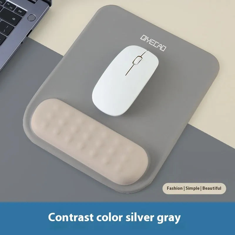 Ergonomic cloth-silicone mouse pad with raised wrist support on a desk