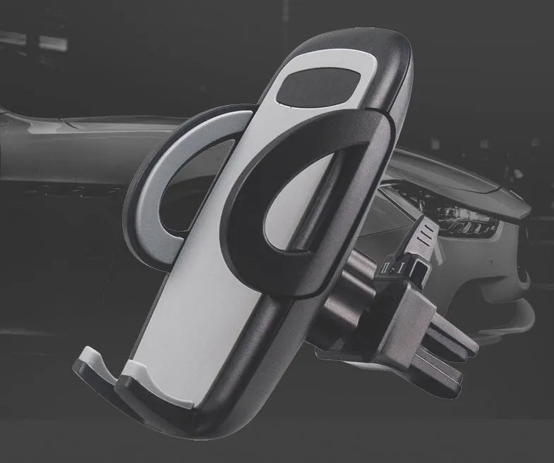 Black plastic mobile phone holder clipped to a car air conditioning vent.