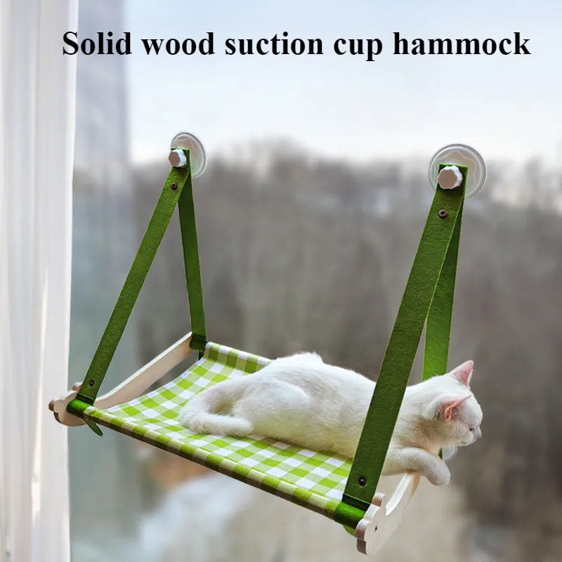 Wooden frame cat hammock with linen mat attached to a window via suction cups, shown in pink colour.