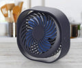 USB charging desk fan with alarm clock display in blue, showing 360-degree rotation capability.