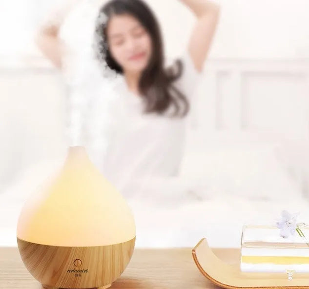 Wood grain finish vase-shaped USB aroma diffuser with 100ml water tank.