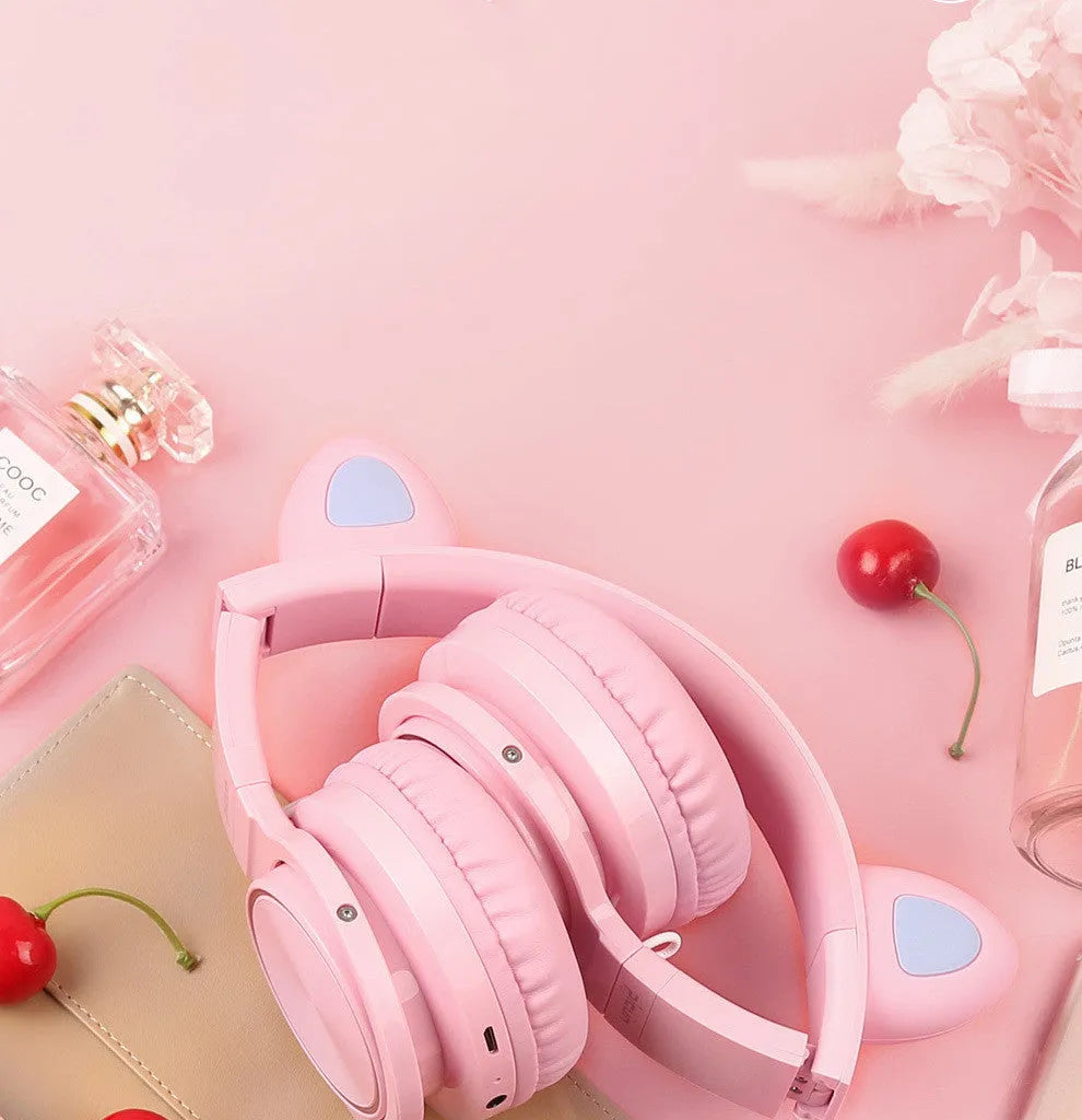 Pink and white wireless Bluetooth headset with head-mounted design and 40mm speakers