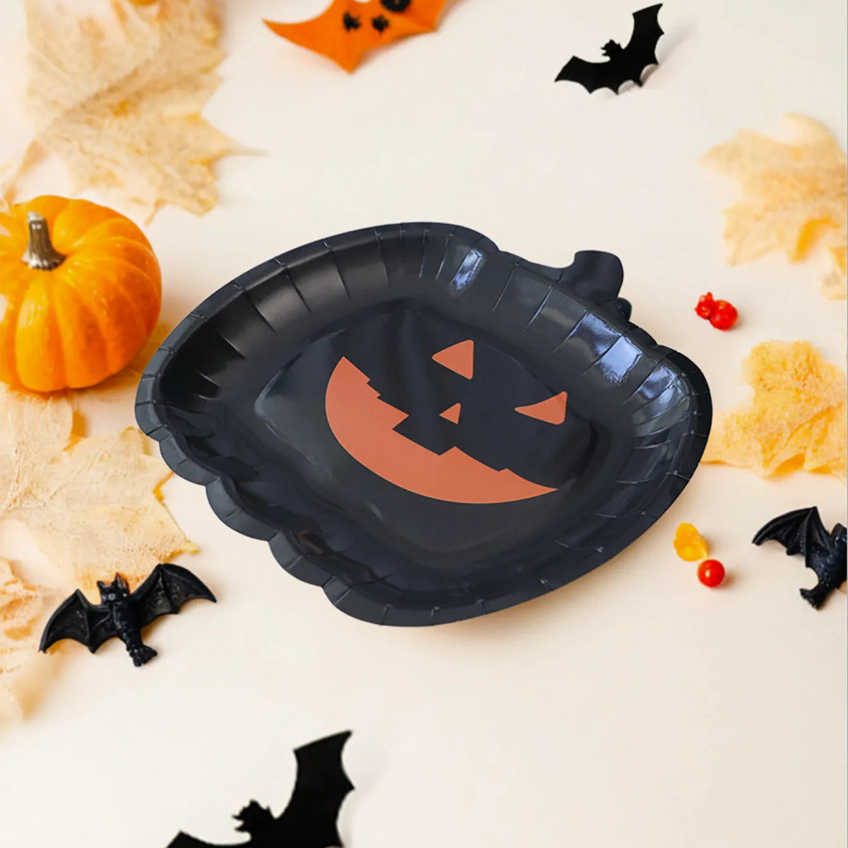 Black Halloween pumpkin design paper plates in 9-inch size showing thickened disposable construction