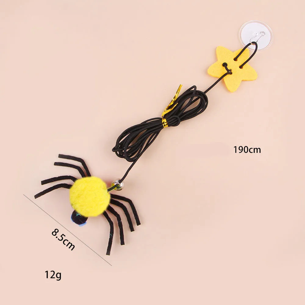 Red and yellow hanging door cat toy with elastic rope, feather, bell, and spider attachments