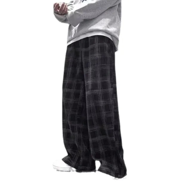 Man wearing black plaid retro loose-fit straight-leg casual trousers.
