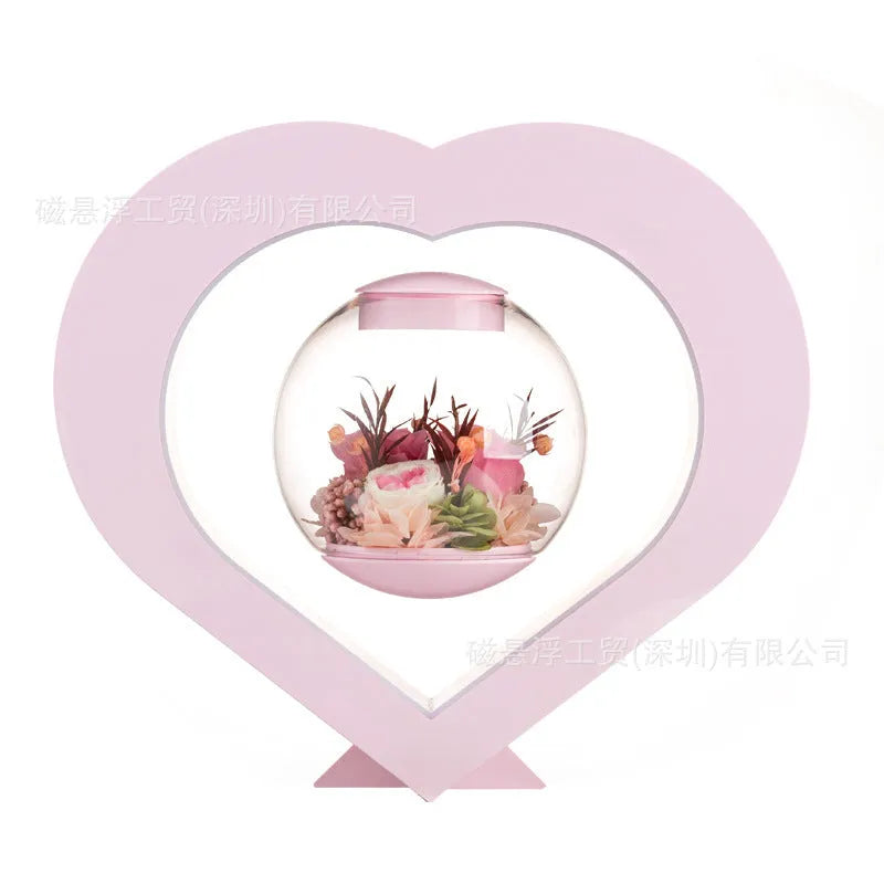 Pink preserved rose ornament with LED lights on a base with audio Bluetooth connectivity.