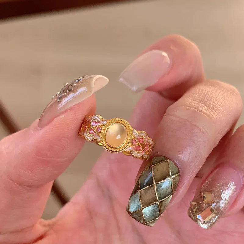 Pink crystal enamel geometric open ring on a gold plated copper band for women.