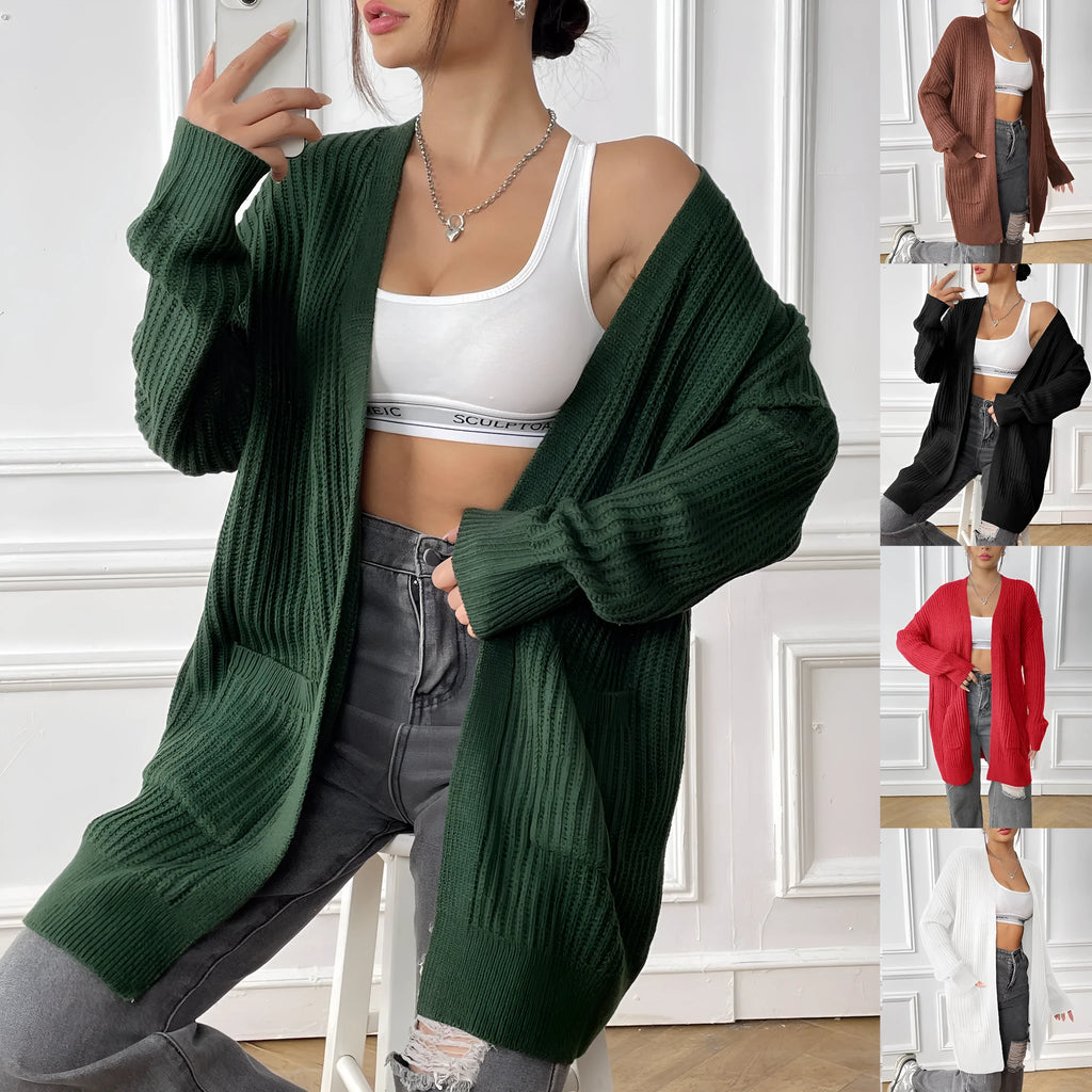 Women's dark green loose fit acrylic cardigan sweater with long sleeves on a hanger.